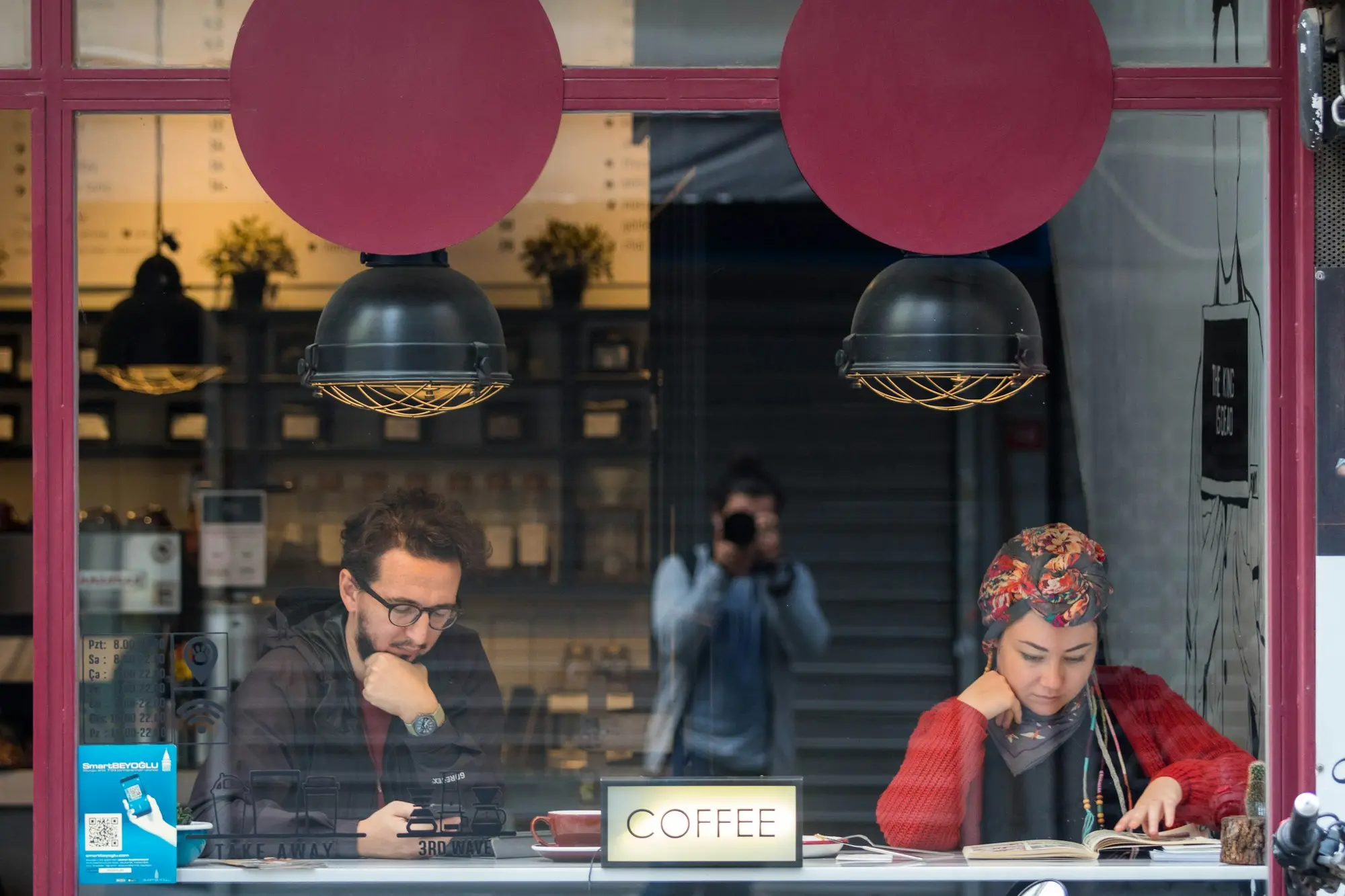 Cafe owners at the window counter of their cafe early in the morning