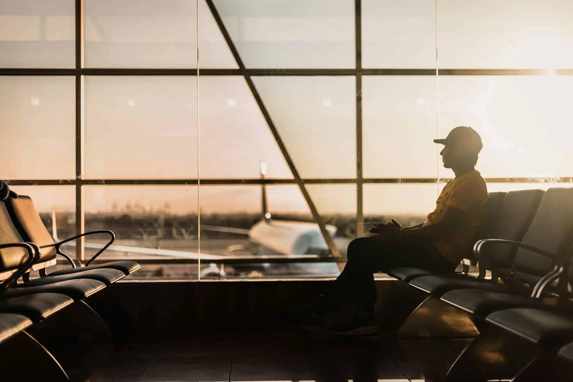 Business traveller silhouetted in an airport departure lounge